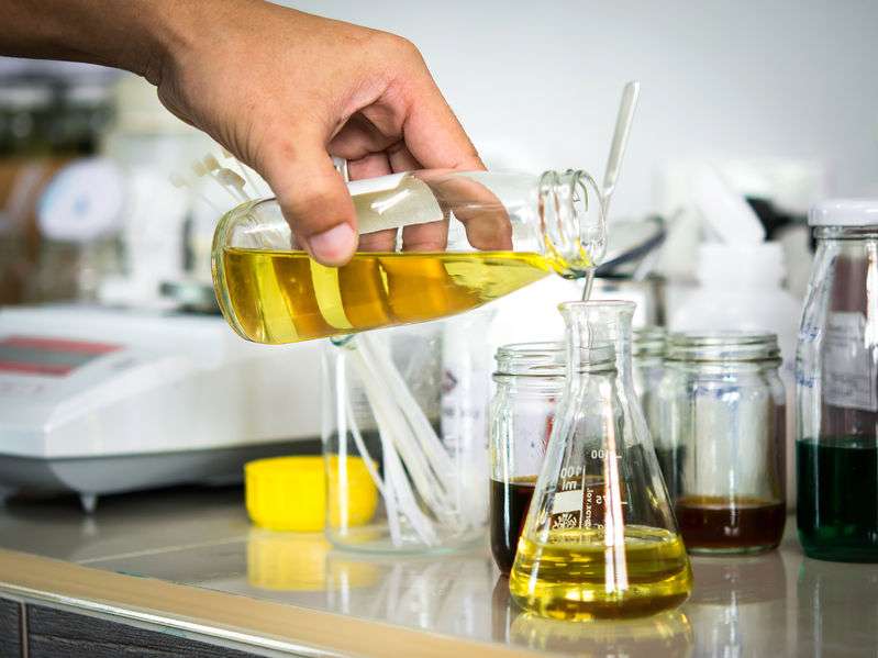 Pao ester engine oil being added to a conical flask 