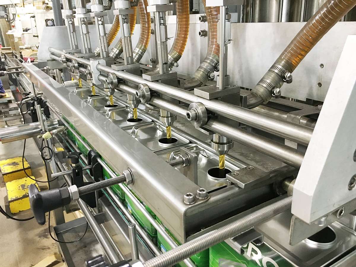 Assembly line in a factory of lubricant supplier filling up cans with oem engine oil