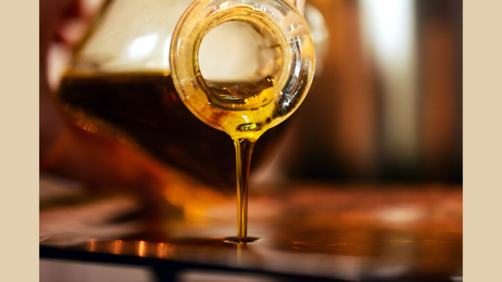 Macro shot of motorcycle engine oil streaming from bottle nozzle